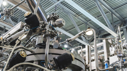 Medical pharma production machine with many tubes and other devices in pharmaceutical factory, pharmaceutical medical production concept background.