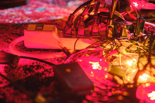 Guitar pedals and effects equipment illuminated by pink stage lighting during live music performance