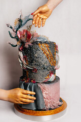 Artistic Fantasy Cake with Gold Hands and Decorative Details