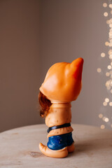 Vintage dwarf figurine in profile with festive warm bokeh background