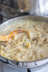 Close-Up of Creamy Mushroom Pasta Cooking in a Pan