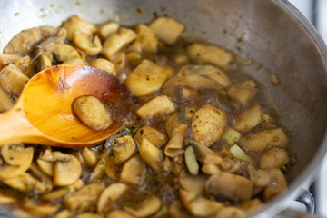 Close-Up of Sautéed Chopped Mushrooms Cooking in a Metal Pan