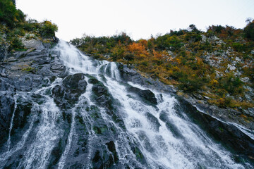 Balea Waterfall cascade on frosty autumn morning in Fagaras Mountains. Transfagarasan Highway, Romania. Travel concept.