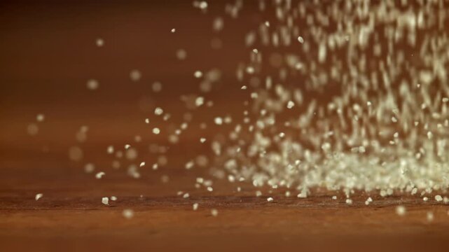 Semolina falls on a wooden table. Filmed on a high-speed camera at 1000 fps. High quality FullHD footage