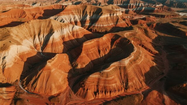 Aerial view of layered red rock formations in a desert canyon landscape - Powered by Adobe