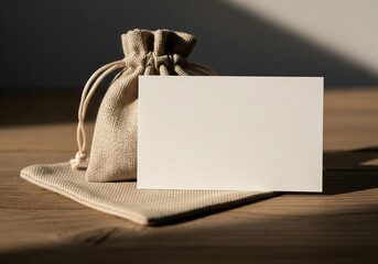 Blank card on linen pouch in warm natural light 