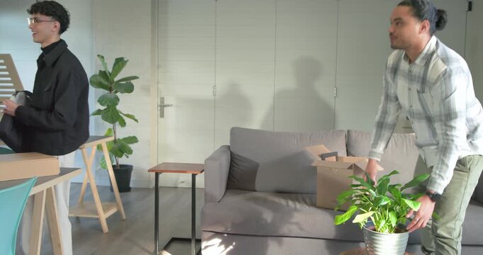 Entering office, coworkers unpacking bubble wrap and revealing purple parts for assembling mount