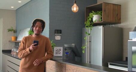 African American man tapping smartphone while barista scanning QR payment code at cafe, copy space - Powered by Adobe