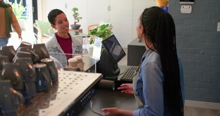 After pickup woman approaching cafe counter with four cups talking to barista hugging partner