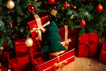 Christmas gifts under tree with green fabric ornament