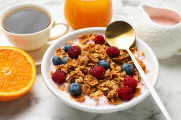 Tasty breakfast. Granola with yogurt and fruits served on white marble table, closeup
