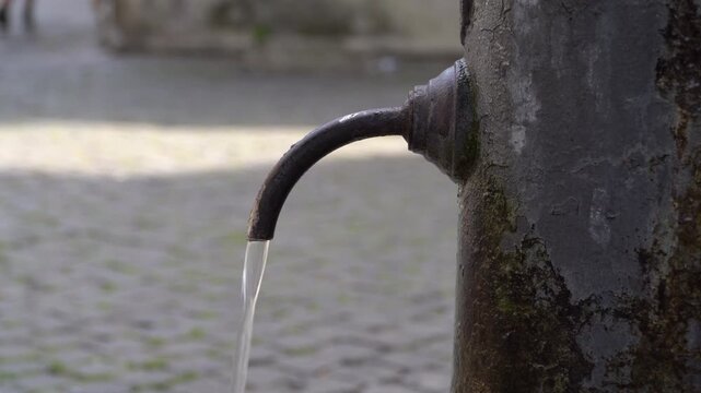 Close-up video showcases "nasone", a typical drinking water street fountain in Rome, Italy. 