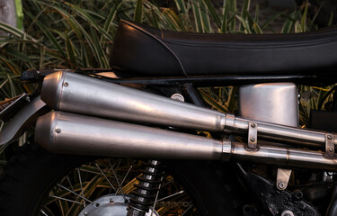 Close-up of the exhaust pipe of a vintage motorcycle.