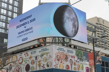 Fototapeta premium outdoor media company Pattison moon phase sign rooftop of Healthy Planet - Yonge & Dundas, Toronto