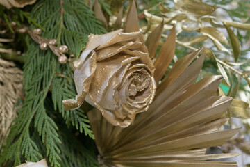 gold rose with decorative foliage close-up