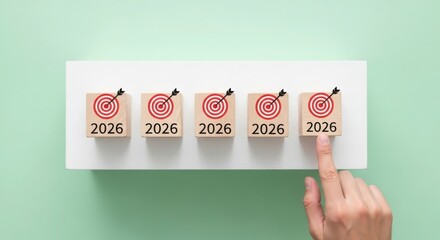 Five wooden blocks showing years and targets for future goals