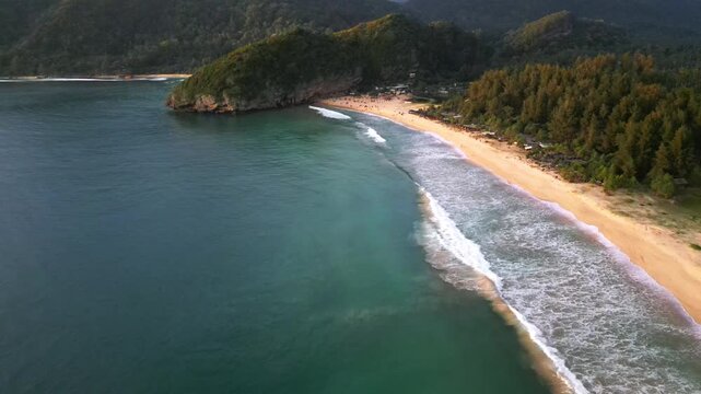 Lhoknga coastline, sea aerial view of beach at sunset by drone in Aceh, Indonesia. popular for surfing waves and surfers