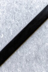 Black Leather Belt on Textured Surface