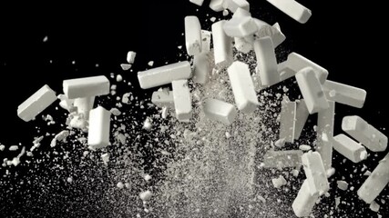 School chalk flies up and falls down on a black background. Filmed on a high-speed camera at 1000 fps. High quality FullHD footage