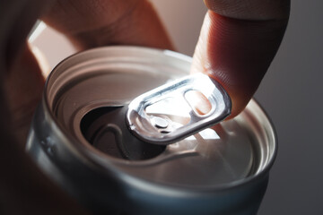 Opening a can with a finger at close range