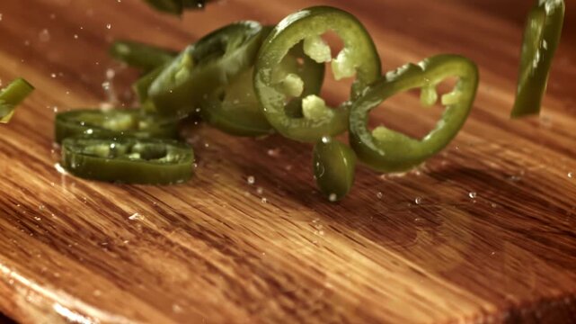 The marinated jalapenos fall onto the board. Filmed on a high-speed camera at 1000 fps. High quality FullHD footage
