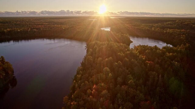 Aerial view looking down on a river wrapped in autumn colors.