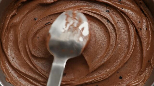 Close Up of Creamy Chocolate Ice Cream Being Stirred with a Spoon
