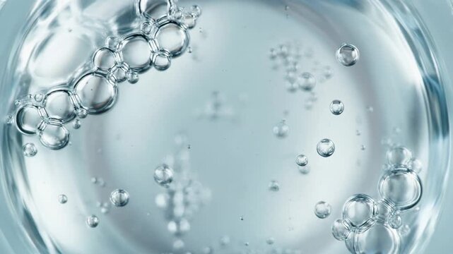 Dynamic bubbles in clear liquid background motion close up