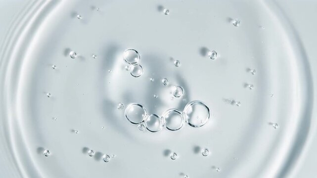 Abstract Clear Liquid Surface with Ripples and Floating Air Bubbles Macro Close-up