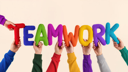 Diverse hands holding colorful teamwork letters financial business yarn concept for successful collaboration and group work