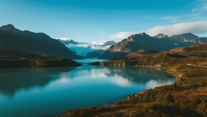 Serene mountain lake reflecting clear blue sky and surrounding peaks under calm weather conditions