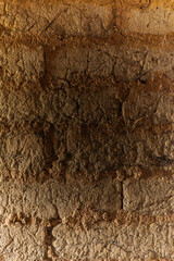 Close-up of traditional adobe wall texture from Susudel, Azuay, Ecuador. Natural earthy surface with handmade construction details, ideal for backgrounds, architecture design and heritage projects.