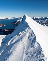 Snowy mountain peak with water view