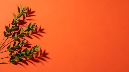 Vibrant Green Leaves Casting Shadows on Orange Background.