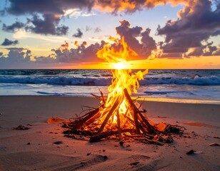 Beach bonfire burning brightly with ocean waves under a vibrant sunset