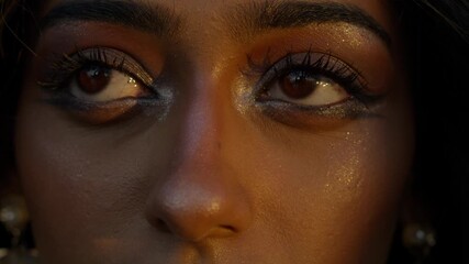 Serene close-up of a woman's closed eyes showcasing elegant makeup and tranquility
