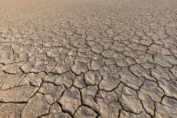 Cracked and dry soil background,Top view of the dried up cracked soil. The ground cracks, hot climate, lack of moisture. Global warming, crop failure, climate change.