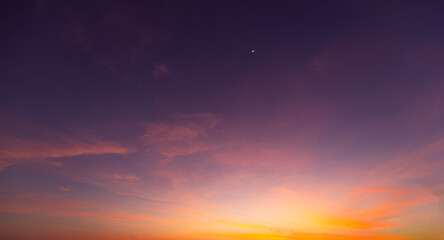 Fototapeta premium Colorful clouds and sky backdrop during twilight,sky and clouds during sunset time background,Twilight sky with crescent moon, soft pink clouds, and gradient colors during peaceful sunset.
