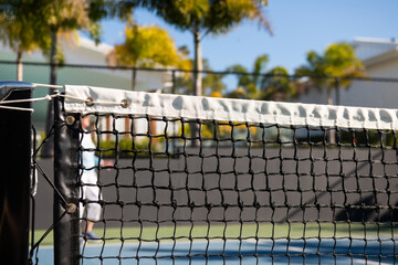 active senior woman playing pickleball outdoors