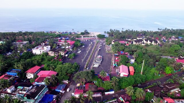 Aerial view of colva beach with parking area and hotels at goa. day time, stable shot, drone shot, 4k.