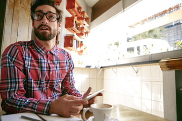 Thinking, waiting and phone with man in cafe for customer service, lunch order and brunch. Hospitality, reflection and late appointment with person in coffee shop for tech, cafeteria or restaurant