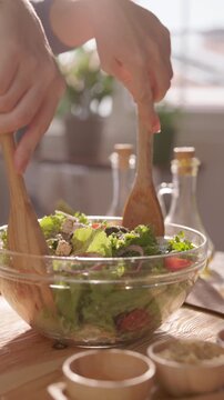 Minimalist Cooking Style Woman Mixing Green Salad in Glass Bowl Vertical Slow Motion Calming Culinary Video Organic Food Preparation Zen Kitchen Aesthetic