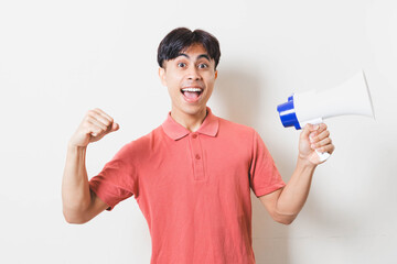 Man holding a megaphone with an excited expression, symbolizing announcement, motivation, promotion, communication, and energetic message on a clean background.