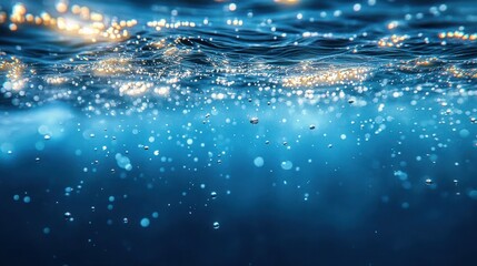 Underwater view showing sparkling water surface with bubbles rising in clear blue ocean water, evoking a sense of calm and freshness