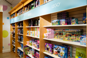 Obraz premium View of LEGO toy sets displayed on organized shelves in a retail store. Toronto, Canada - December 3, 2025.