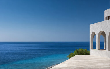 Coastal view from a modern building overlooking calm blue waters in a serene environment