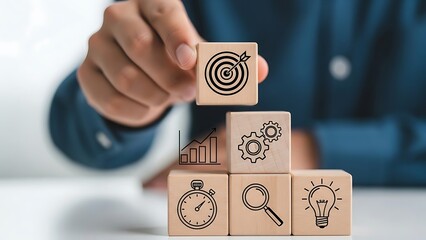Business strategy and goal achievement represented by wooden blocks with icons of target, clock, magnifying glass, light bulb, and gears