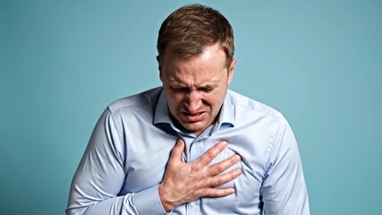 A Man Experiencing Chest Pain, Anguish, And Physical Discomfort on a Blue Backdrop