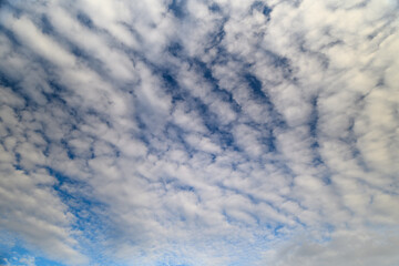 Dynamic and Intense Cloud Patterns Beautifully Stretching Across a Bright Blue Sky