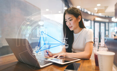 Young adult woman using cloud storage data connection system technology workflow using laptop working in cafe